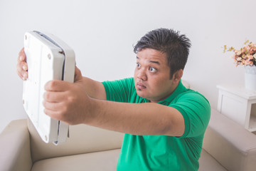 Guy disappointed with his scale weight