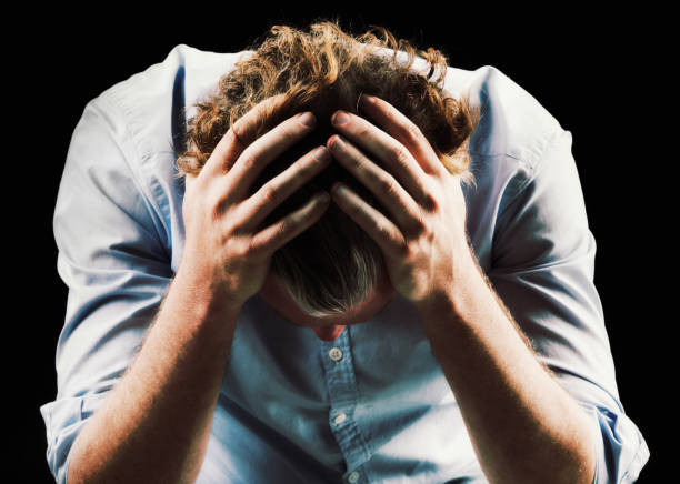 Man holding head with both hands