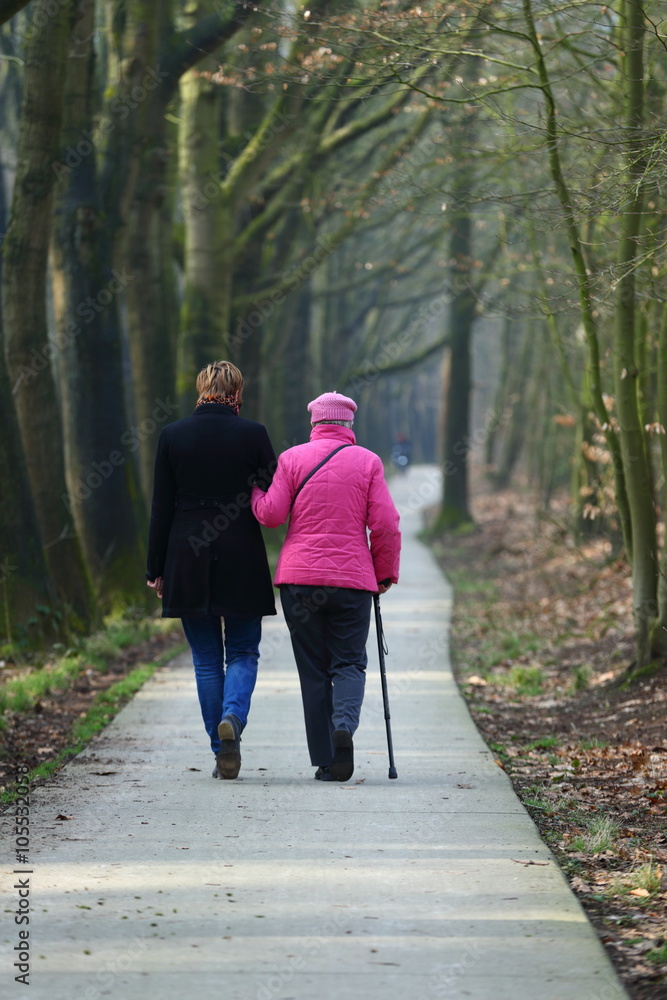 two women walking in park